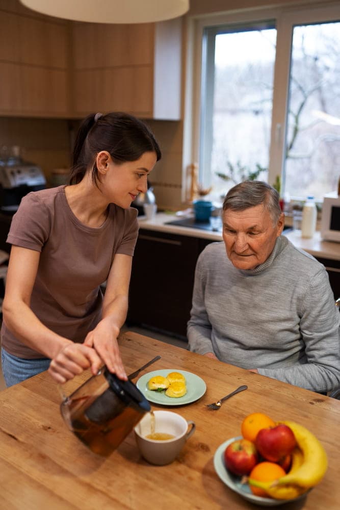 Family caregiver helping an older loved one at home